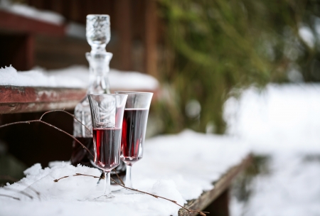 Decanter and wineglasses of red wine outdoors の写真素材