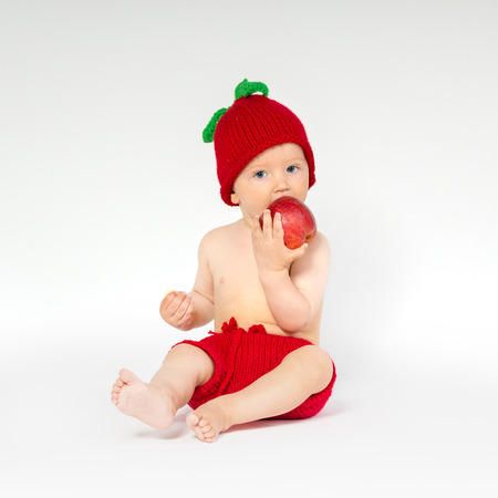 Cute toddler with appleの写真素材