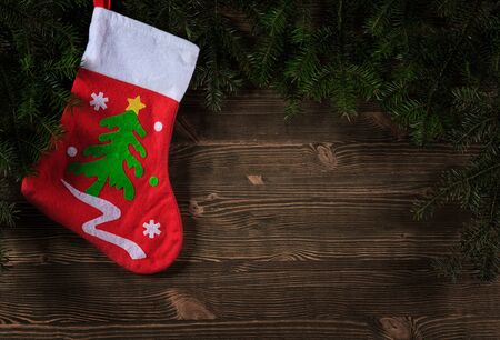 Old planks adorned with Christmas tree twigs and decorationsの写真素材