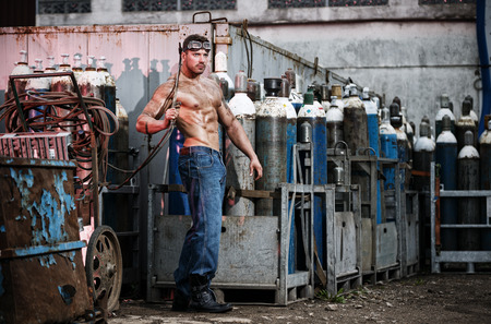 Muscular man with an acetylene burnerの写真素材