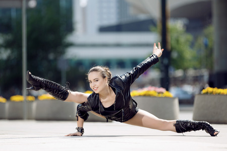 Beautiful woman performing acrobatics in the city