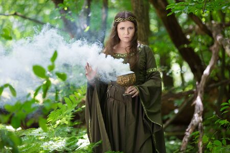 Elf performing spells in the forest with magical smoke