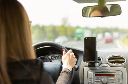 A woman driving a car on a fast road