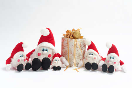 Christmas present and five gnomes isolated on white backgroundの写真素材