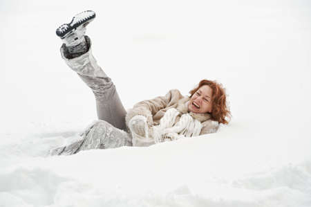 Attractive red-haired woman having fun in winters day.の写真素材