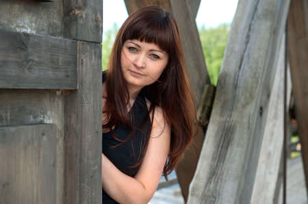 Young, beautiful woman looks at the camera from old-time watch box.の写真素材