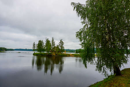 Daugava River near Koknese. Island with sauna in Daugava river. Landscape with birch at Daugava coast. Classical Latvian landscape. Latvian countryside. View of little island in river Daugava, Latvia.の写真素材