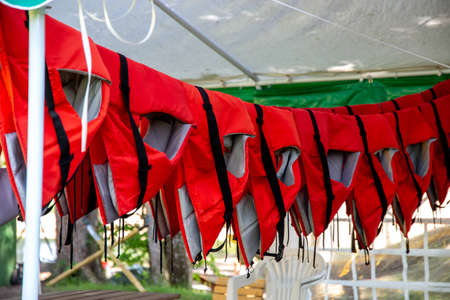 Life jackets drying in the summer shed neat the river in Latvia. Life jackets on the Gauja shore.