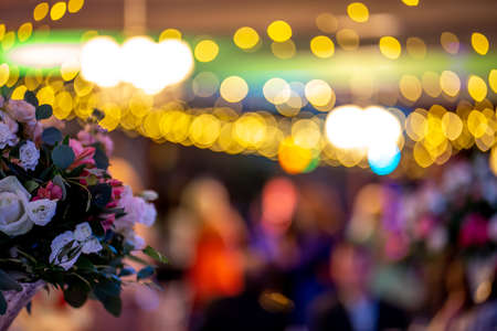 Bouquet of flowers on background of colorful bokeh light. Closeup of wedding flowers bouquet and blurred colorful lights in back.の写真素材