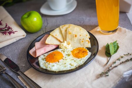 Arepa paisa with eggs, ham and cream cheese (Colombian breakfast)の写真素材