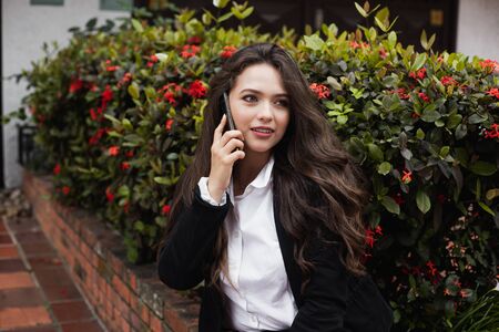 Happy woman calling, with gorgeous hair and gorgeous. businesswomanの写真素材