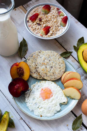Breakfast with arepa chia and fruits such as strawberries, peaches and avocados, as well as eggsの写真素材