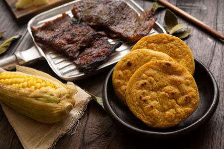Breakfast with arepa chia and fruits such as strawberries, peaches and avocados, as well as eggsの写真素材