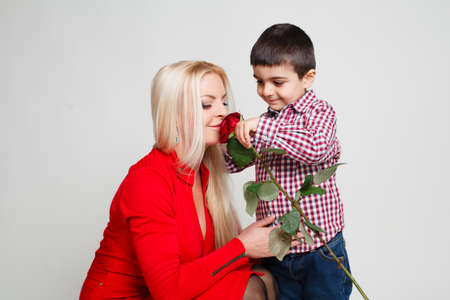 Son gives his mother flowers. Spring, March 8, International Womens, Mothers day, family holiday.の写真素材