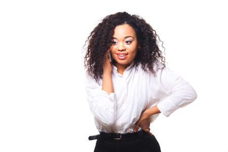 Beautiful African American woman talking on cell phone, isolated on white backgroundの写真素材