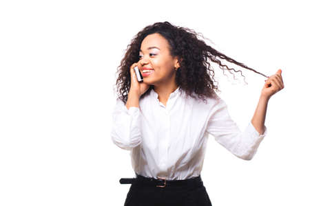 Beautiful African American woman talking on cell phone, isolated on white background