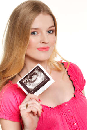 pregnant woman caressing her belly over white backgroundの写真素材