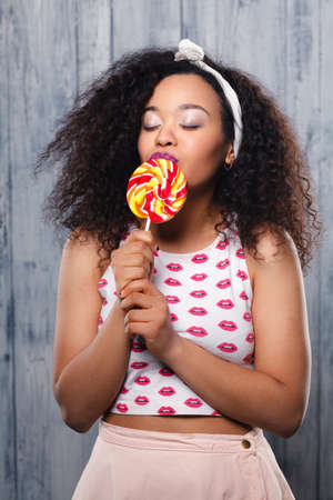 Funky afro lady with lollipop,  funny girl,の写真素材