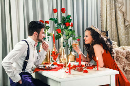 marriage proposal, man give ring to his girl, young happy couple romantic date at restaurant, celebrating valentine dayの写真素材