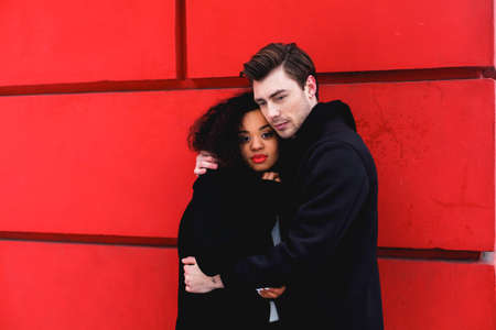 loving couple in a winter day in the city,African girl  and caucasian manの写真素材