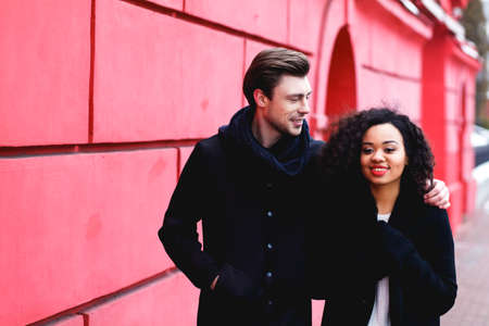 loving couple in a winter day in the city,African girl  and caucasian man