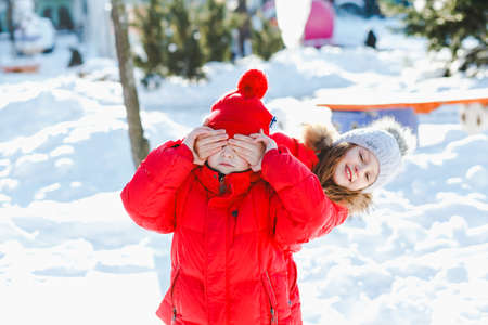 Happy children play down in the snowの写真素材