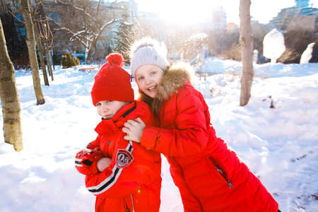 Happy children play down in the snowの写真素材