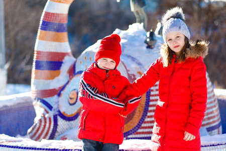 Happy children play down in the snowの写真素材