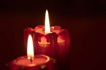 Christmas advent wreath with burning candles laid on table with black backgroundの写真素材