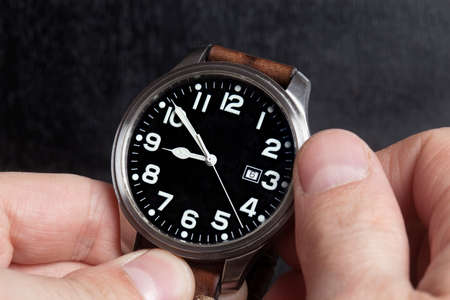 Man hand with elegant expensive watch with leather strapの写真素材