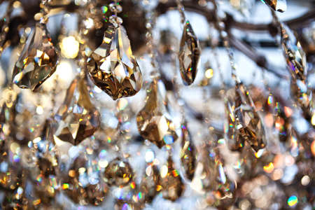Crystal pendants background in golden and blue tones.の写真素材