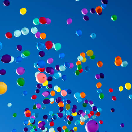 colorful balloons on a blue sky backgroundの写真素材