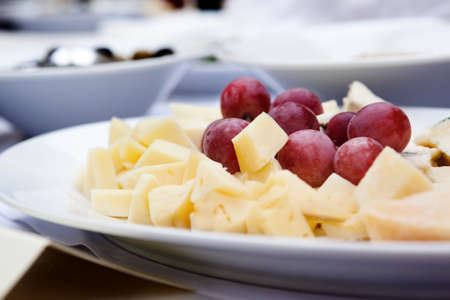 cheese platter with grapes  light background. Selective focusの写真素材