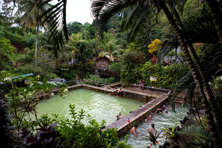 Bali, Indonesia - Mar 12, 2014 : People soak and relax in hot mineral waterfallのeditorial素材
