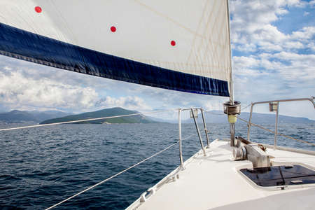 Front part of a sailboat, on full sails in Ionian sea