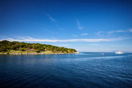 the ship swims to the islandの写真素材