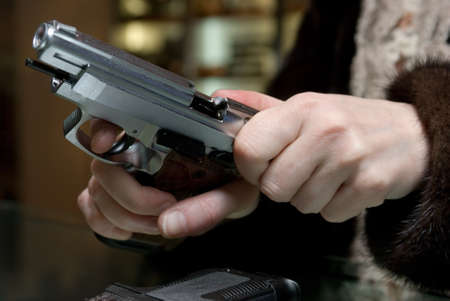 Close up of woman holding a gun