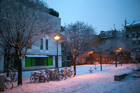 snow covered bicycles on the streetの写真素材