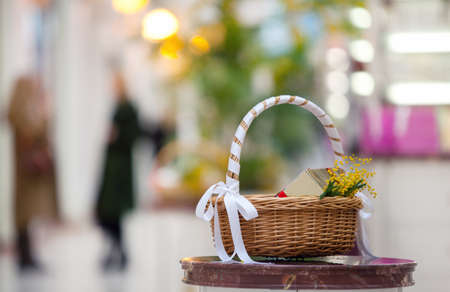 basket with a gift and flowers shop. the people in the background not in focusの写真素材