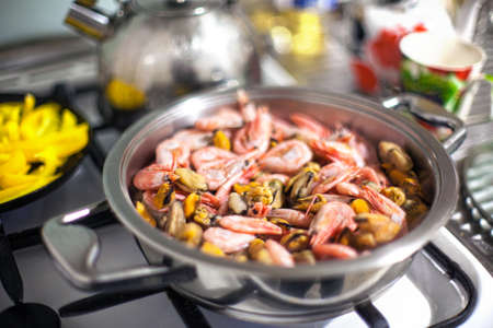 seafood being cooked in a silver frying pan