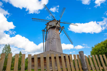 Old wooden mill on a background of blue skyの写真素材