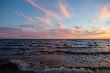 North seascape on Lake Onega - waves beat against the granite shore which reflects the rays of the...