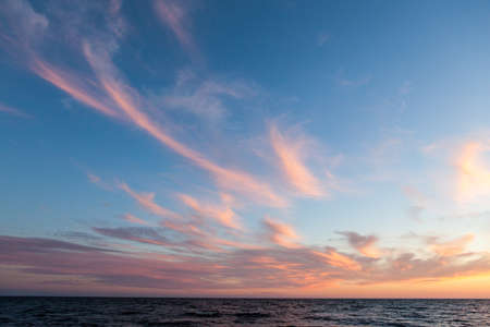 North seascape on Lake Onega - waves beat against the granite shore which reflects the rays of the...