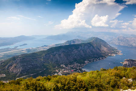 Panoramic view of the airport runway near the city, on the Adriatic Sea, from a great mountain height. Aerial view of Tivat, Kotor Bay, Montenegro.の写真素材