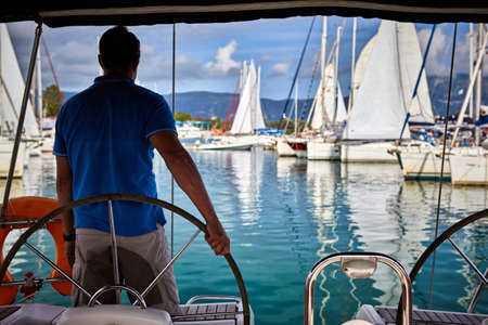 Young man sailing in caribbean seaの写真素材