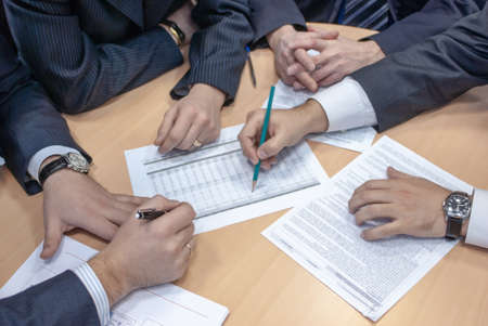 group of businessmen vigorously discuss plans and strategies of the company and conclude contracts...