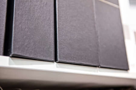 folders for papers on a shelf in a row in the office