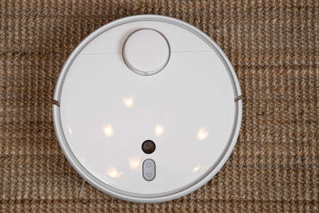 Robot vacuum cleaner performs automatic cleaning of the apartment at a certain time. Smart home.の写真素材