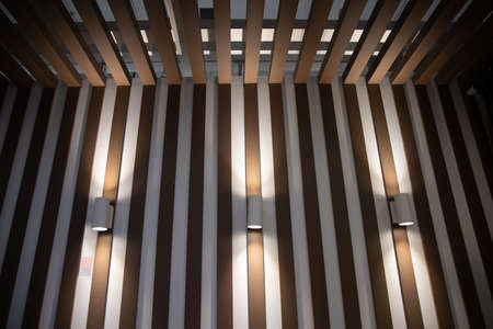 Modern lamps on the wooden wall of the interior.loft style room