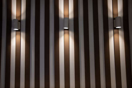 Modern lamps on the wooden wall of the interior.loft style roomの写真素材